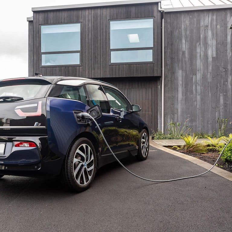 BMW i3 plugged into wall charger